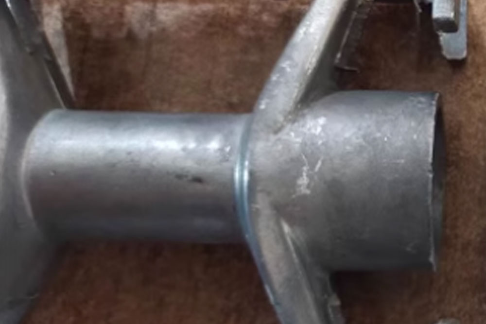 Unfinished metal parts with rough surfaces before vibratory finishing treatment.
